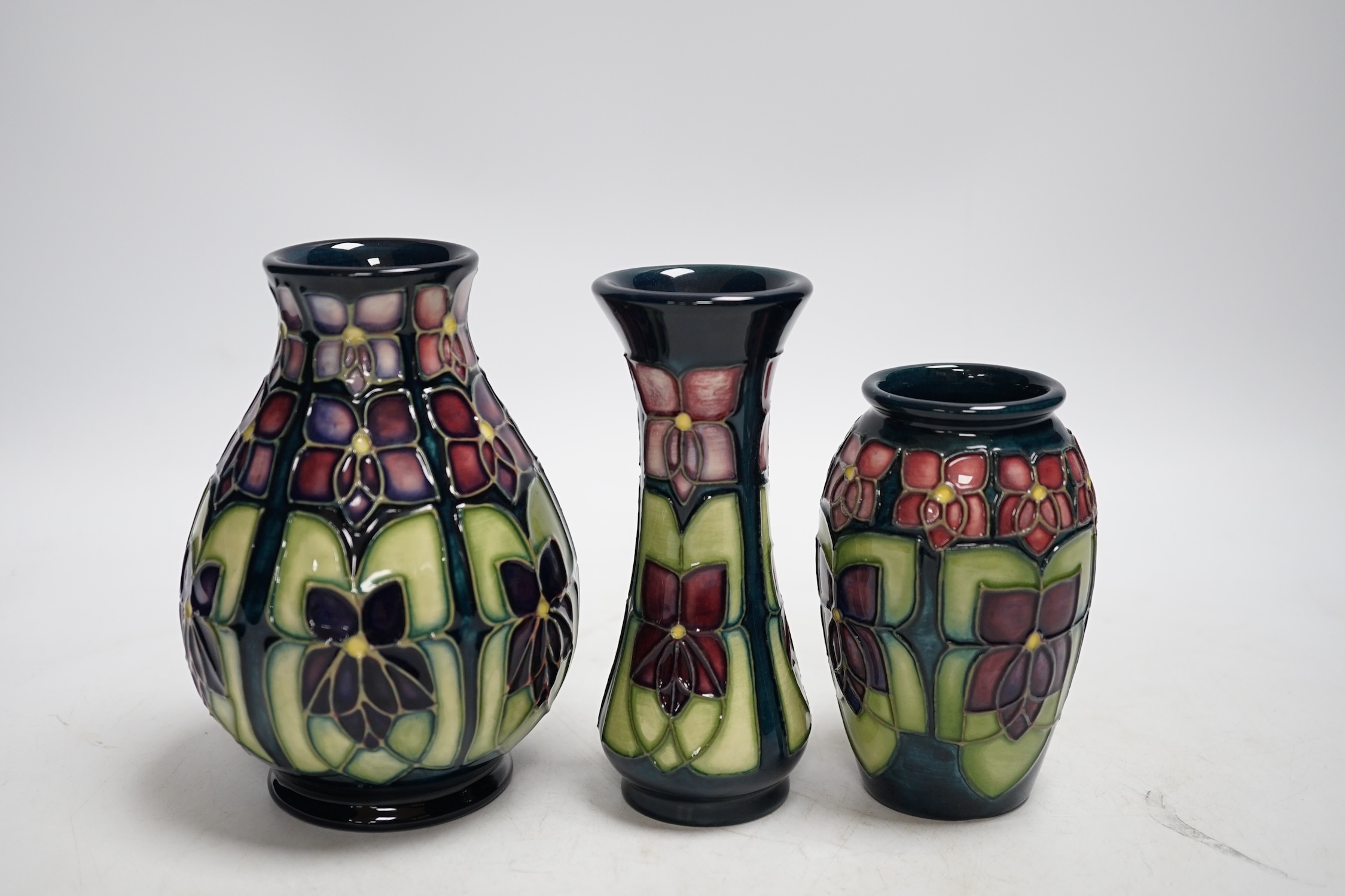 Three Moorcroft violet pattern vases, tallest 13.5cm